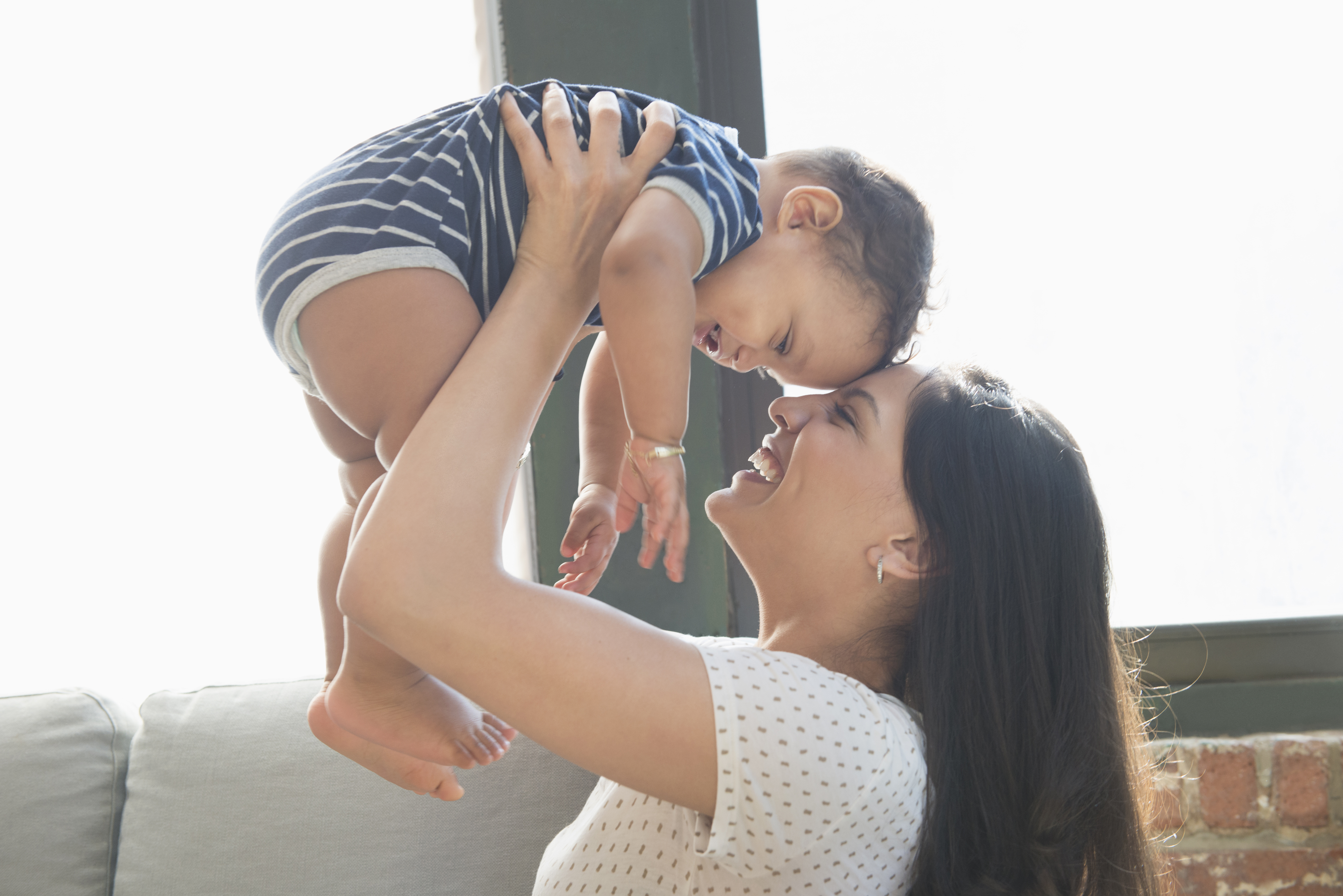 Parent holding child in the air