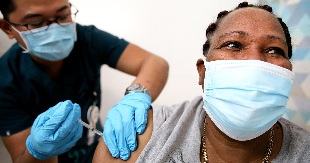 Patient in mask getting vaccine