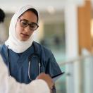 Two healthcare workers talking in a hospital