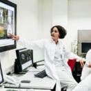 Healthcare workers looking at medical images on a screen