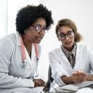 Doctors looking at a computer