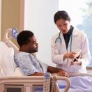 Doctor showing patient a tablet screen.