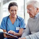 Doctor showing tablet to patient