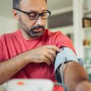 Person using blood pressure cuff