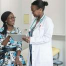 Doctor showing tablet to patient