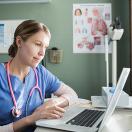 Woman doctor using a computer.