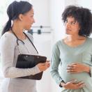 Doctor talking to pregnant patient