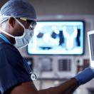 Surgeon standing in front of a monitor