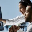 Healthcare workers looking at display screen