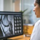 Healthcare worker looking at medical image on computer