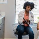 Doctor showing tablet to patient