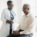 Doctor showing tablet to patient