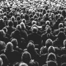 people sitting in a theater, population