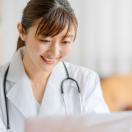 A doctor teleconsulting using a laptop computer