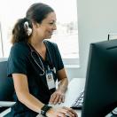 A doctor checking on patient data on a desktop computer