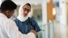 Two healthcare workers talking in a hospital