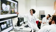 Healthcare workers looking at medical images on a screen