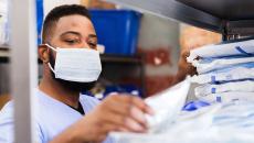 Healthcare worker in mask getting supplies