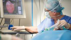 Healthcare worker looking at a medical image display.