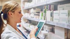 Pharmacist taking inventory with a tablet