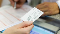 person holding an insurance card.