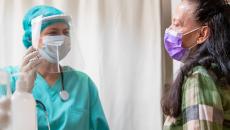 Doctor in PPE with patient in mask