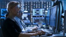 Cybersecurity employees in a control room.