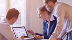 Group of businesspeople looking at a laptop