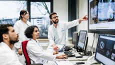 Healthcare workers pointing at a medical image on a display