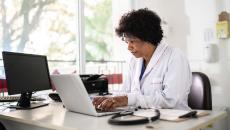 Health professional at computer