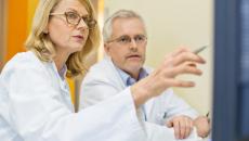 Female doctor pointing at screen.