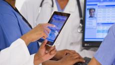 EHR on tablet with doctor scrolling