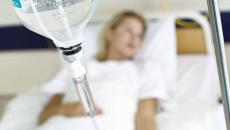 Patient lying in hospital bed with IV drip