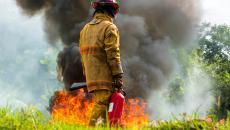 First responder walking by fire.