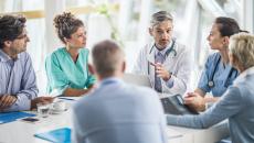 Doctors, nurses and healthcare executives meeting around a table