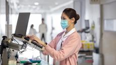 A medical professional using a computer at a hospital.