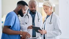 Group of healthcare workers looking at a tablet