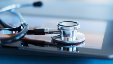 A stethoscope resting on a tablet