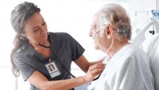 Healthcare worker checking patient with stethoscope