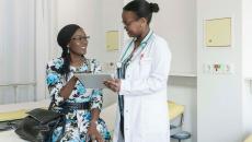 Doctor showing tablet to patient