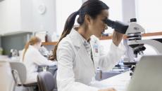 Lab worker using a microscope