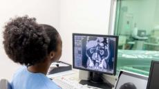 Healthcare worker looking at x-ray image on monitor