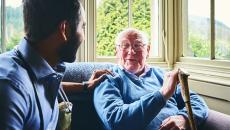 Care worker talking to senior man