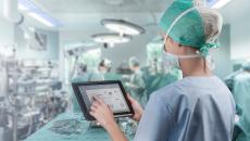 Healthcare worker in surgery room with tablet