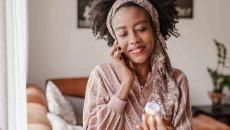 Person on the phone holding pill bottle