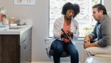 Doctor showing tablet to patient