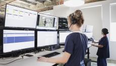 Healthcare professionals in front of monitors