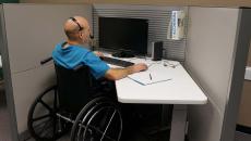 Person in wheelchare at office desk