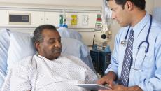 doctor using tablet with hospital patient