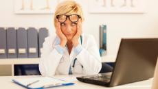 Frustrated doctor at laptop